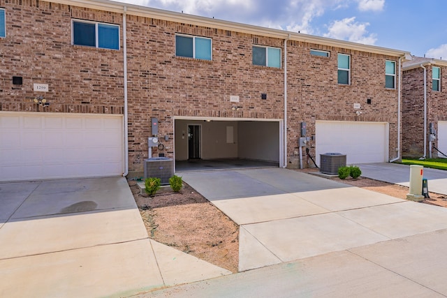 multi unit property featuring a garage and central air condition unit