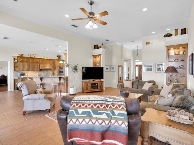 living room featuring ceiling fan, ornamental molding, and light tile patterned floors