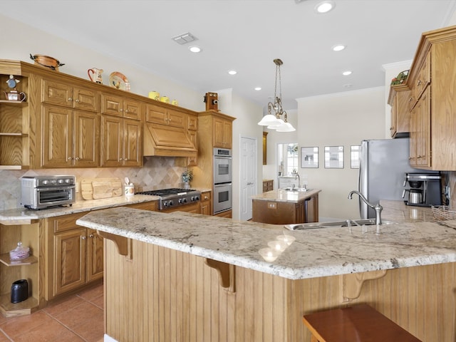 kitchen with kitchen peninsula, a kitchen breakfast bar, custom range hood, pendant lighting, and sink