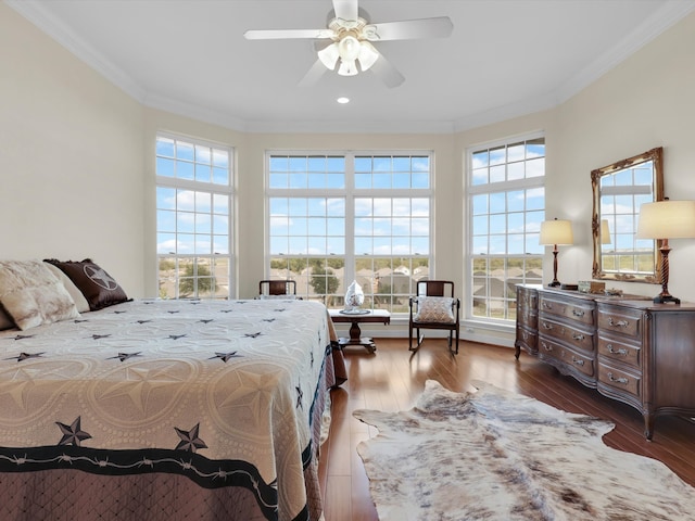 bedroom featuring crown molding, ceiling fan, and dark hardwood / wood-style flooring