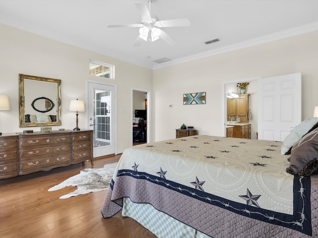 bedroom with ornamental molding, ensuite bathroom, wood-type flooring, and ceiling fan