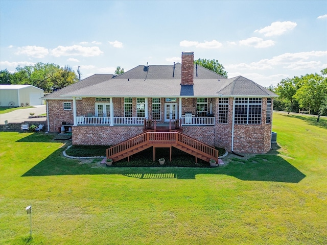 back of house featuring a yard and a deck