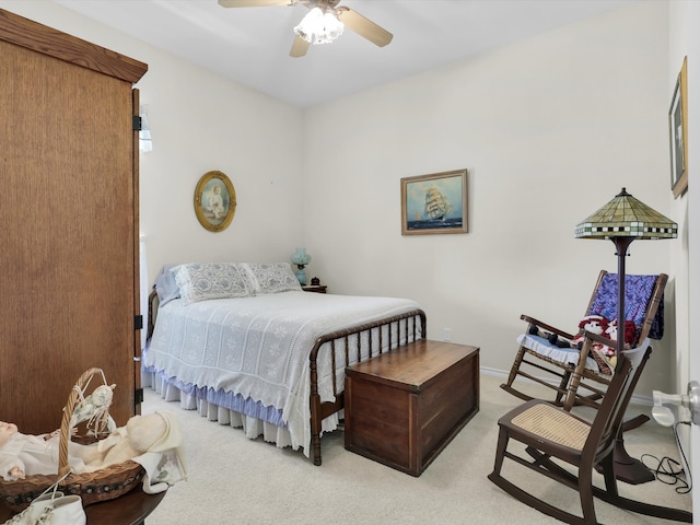 bedroom featuring light colored carpet and ceiling fan