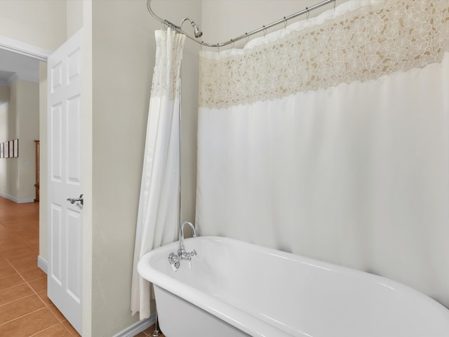 bathroom with a tub and tile patterned floors