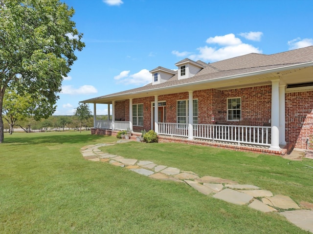 view of front of property with a porch and a front lawn