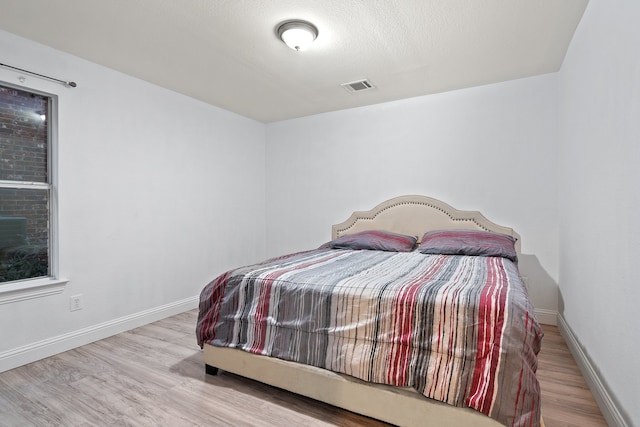 bedroom with light wood-type flooring