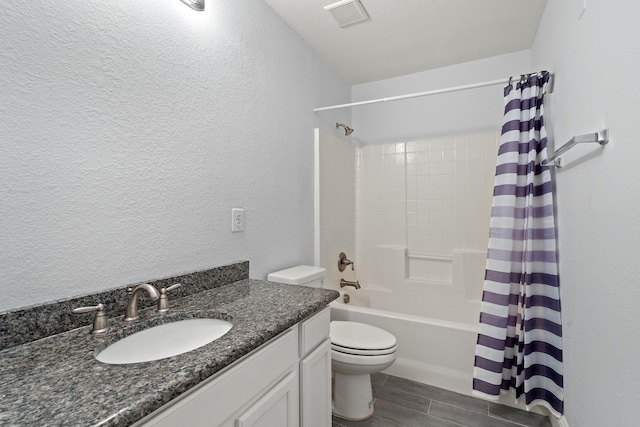 full bathroom featuring hardwood / wood-style flooring, toilet, shower / tub combo, vanity, and a textured ceiling