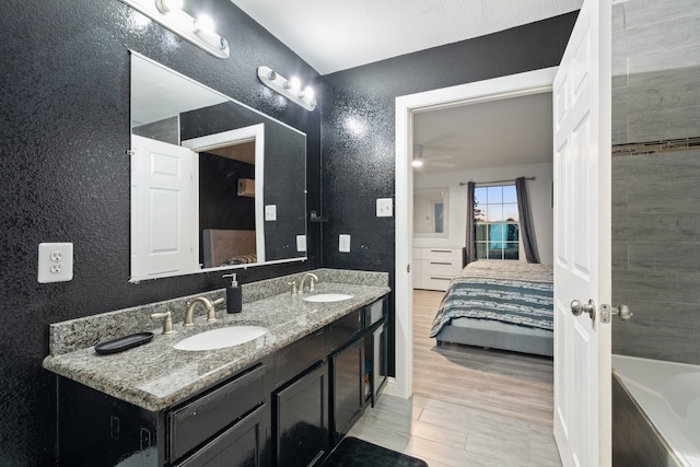 bathroom with vanity, ceiling fan, and wood-type flooring