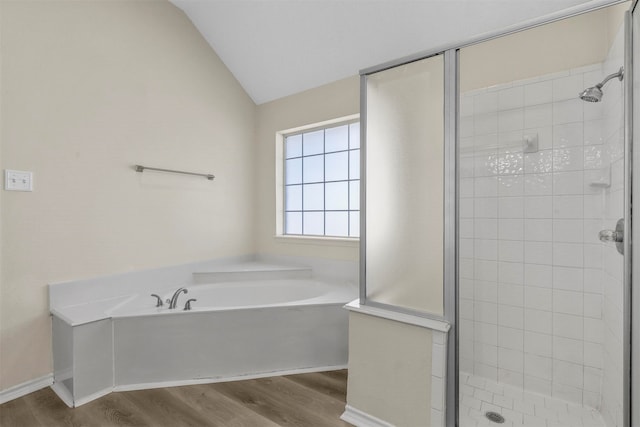 bathroom featuring independent shower and bath, hardwood / wood-style flooring, and lofted ceiling