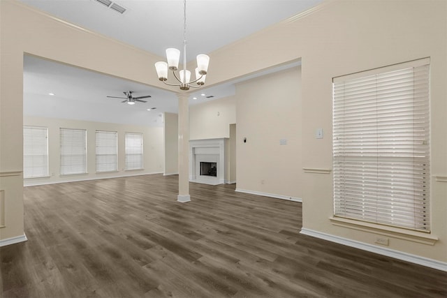 unfurnished living room with ceiling fan with notable chandelier and dark hardwood / wood-style floors