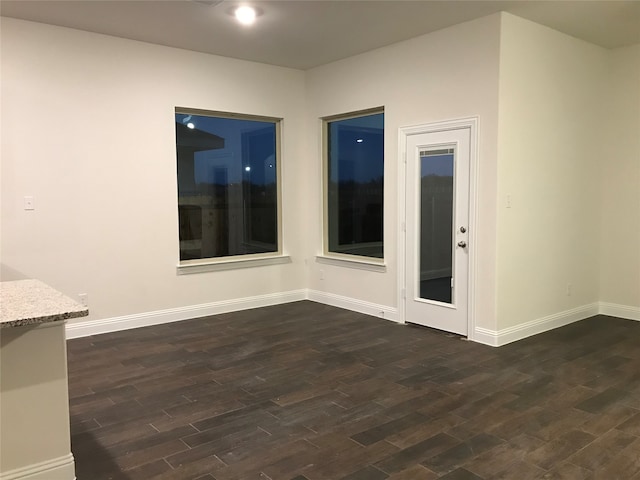 spare room with dark hardwood / wood-style floors