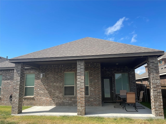 4111 Beamer Dr, Forney, TX 75126 - back of house featuring roof with shingles, a patio area, and brick siding