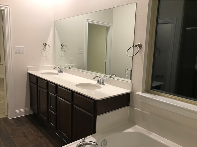 bathroom featuring a bathtub, wood-type flooring, and vanity