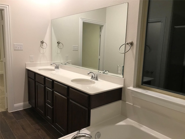 4111 Beamer Dr, Forney, TX 75126 - bathroom featuring a sink, double vanity, and a tub