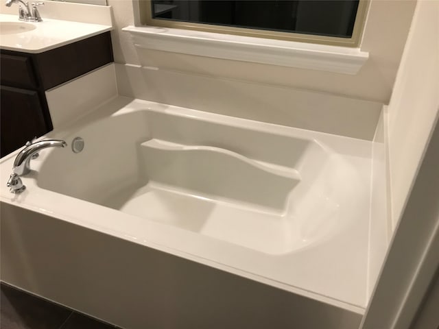 bathroom with a bath and vanity