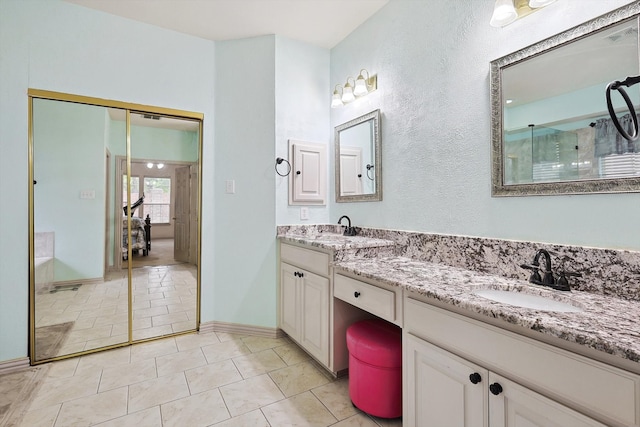 bathroom featuring tile patterned flooring, a shower with door, and vanity