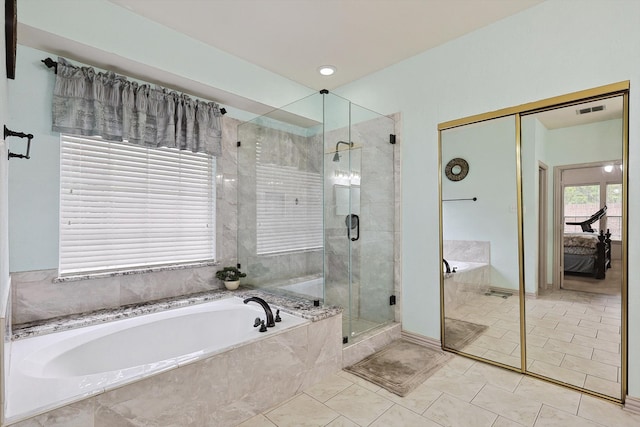 bathroom featuring shower with separate bathtub