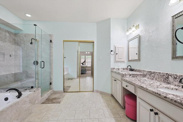 bathroom featuring tile patterned flooring, vanity, and plus walk in shower