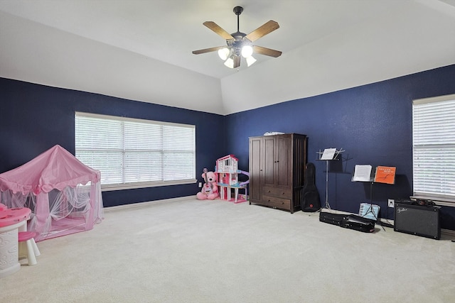 rec room featuring ceiling fan, carpet floors, vaulted ceiling, and a wealth of natural light