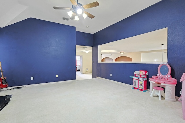 game room with vaulted ceiling, ceiling fan, and light colored carpet