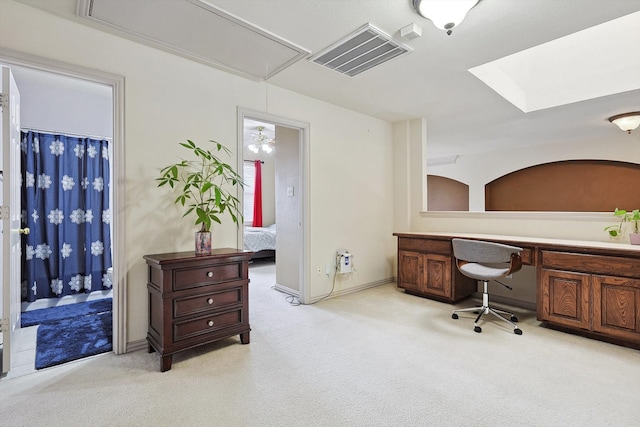 carpeted office space with built in desk