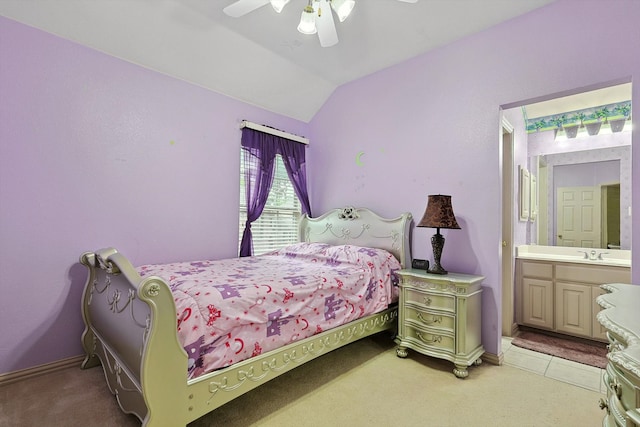 bedroom with lofted ceiling, ceiling fan, ensuite bathroom, sink, and light carpet