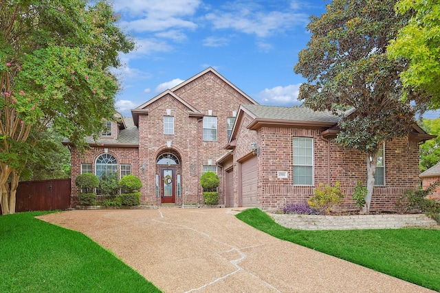 view of front property with a garage and a front lawn