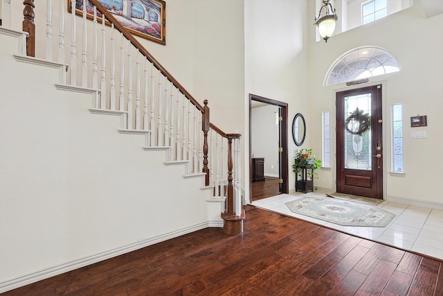 foyer with wood-type flooring and a high ceiling