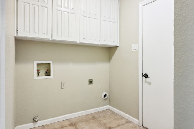 clothes washing area featuring washer hookup, light tile patterned floors, electric dryer hookup, cabinets, and gas dryer hookup