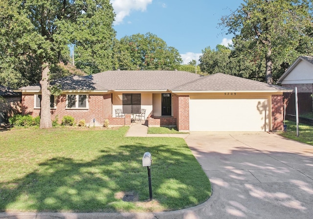 ranch-style house featuring a front lawn and a garage