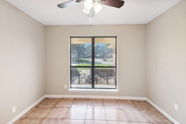 unfurnished room with ceiling fan and light tile patterned floors