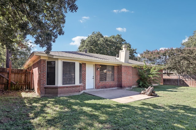 back of property featuring a patio and a lawn