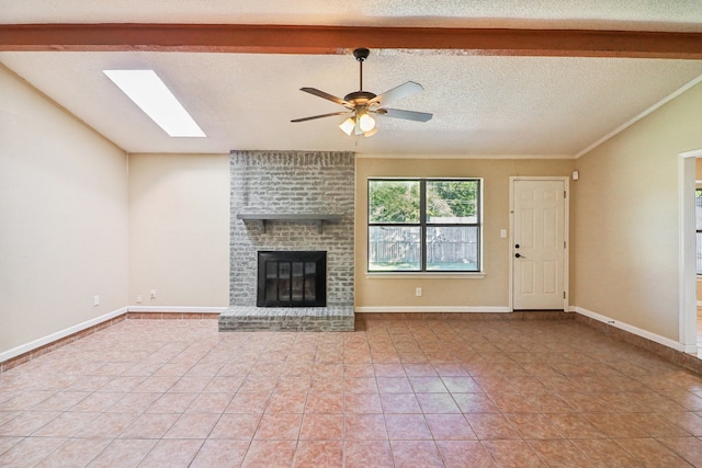 unfurnished living room featuring a brick fireplace, light tile patterned floors, beamed ceiling, a textured ceiling, and ceiling fan