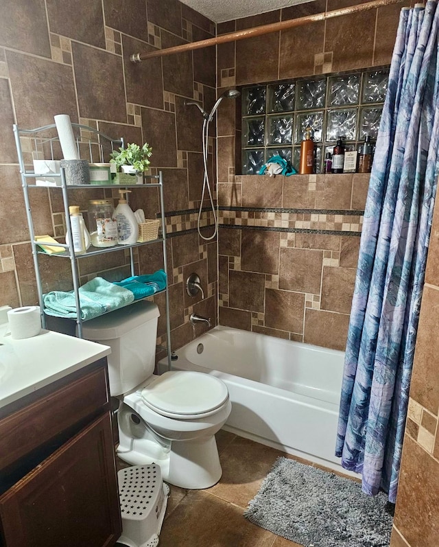 full bathroom featuring tile walls, shower / bath combo with shower curtain, vanity, tile patterned flooring, and toilet