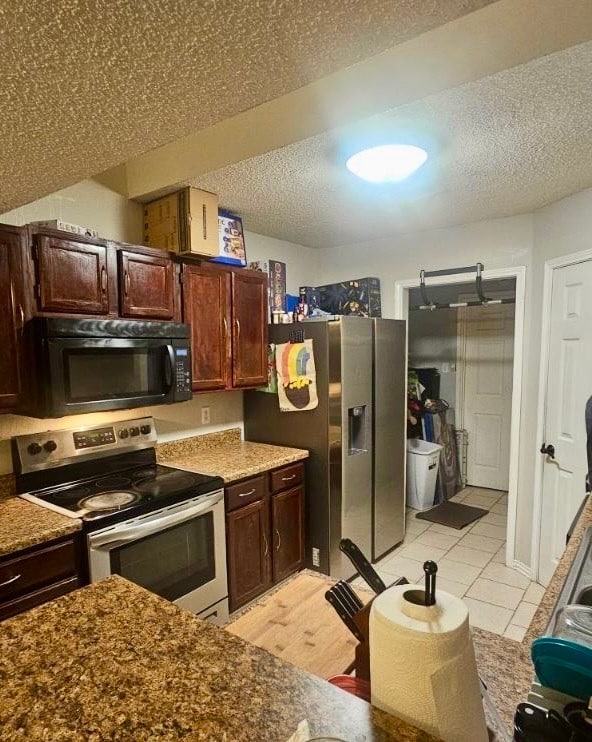 full bathroom with tile walls, tile patterned flooring, shower / tub combo, vanity, and toilet