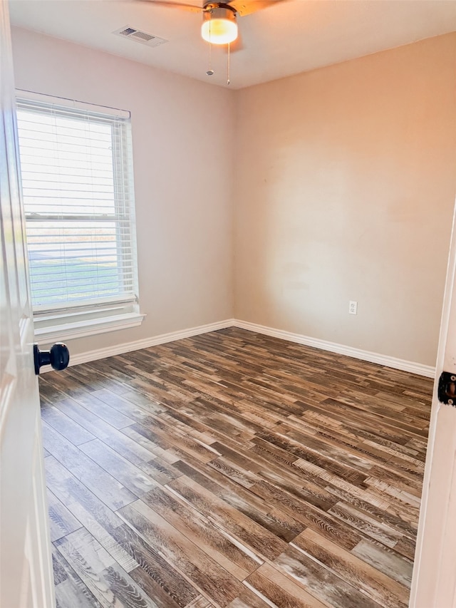 unfurnished room with ceiling fan and dark wood-type flooring