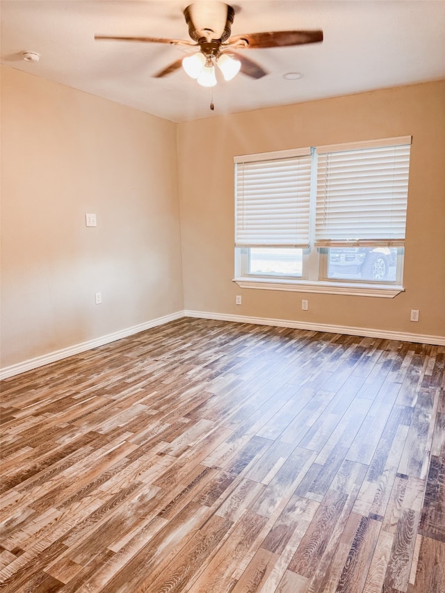 unfurnished room with ceiling fan and hardwood / wood-style flooring