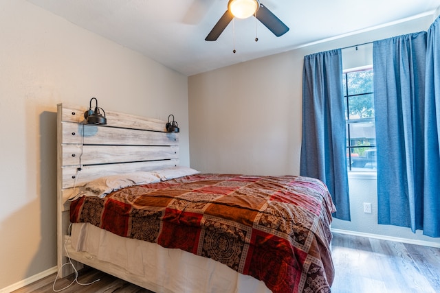 bedroom featuring ceiling fan and dark wood-type flooring