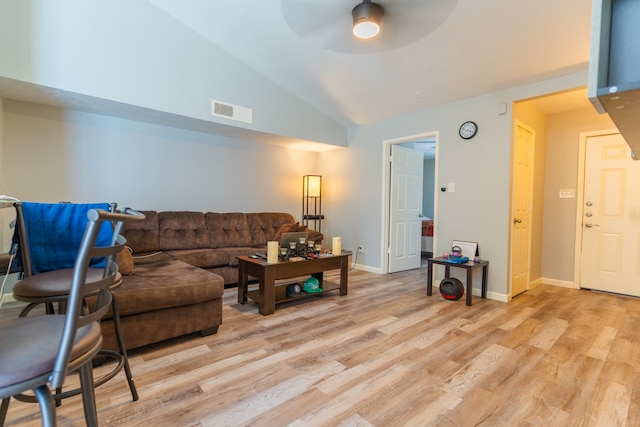 living room with ceiling fan, light hardwood / wood-style flooring, and vaulted ceiling