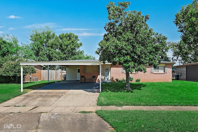 ranch-style house featuring a carport, central AC unit, and a front yard