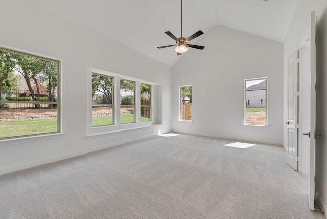 spare room with high vaulted ceiling, carpet, baseboards, and a ceiling fan