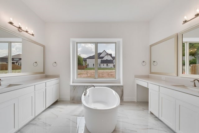 full bathroom featuring marble finish floor, two vanities, and a sink