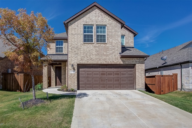 view of front property featuring a front yard and a garage