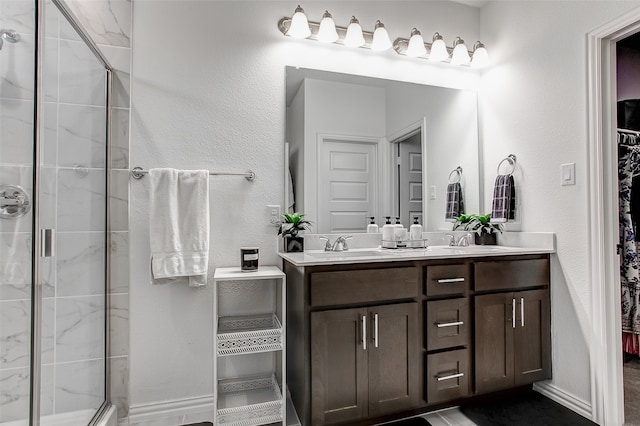 bathroom featuring vanity and an enclosed shower