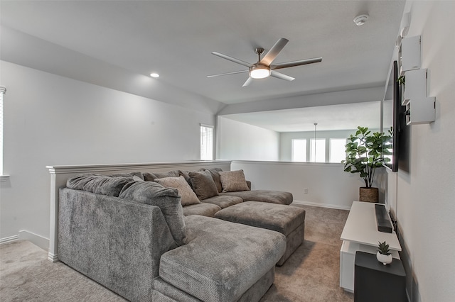 carpeted living room featuring ceiling fan