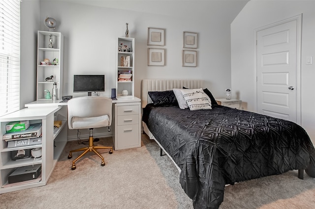 bedroom with vaulted ceiling and light carpet