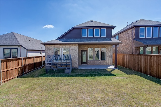 back of property with a yard and a patio area