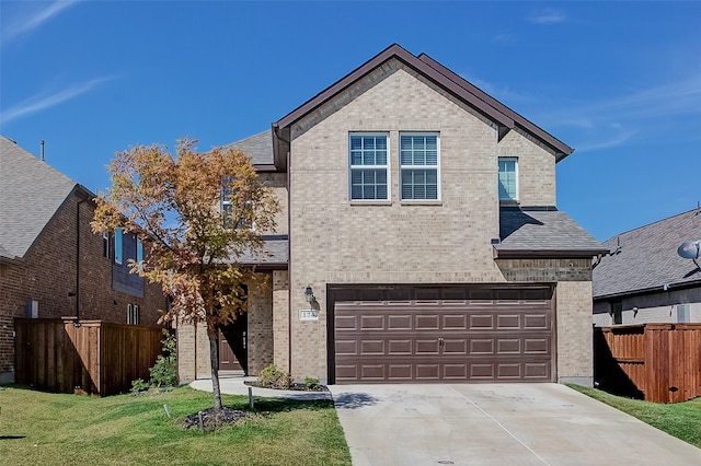 view of front facade with a garage and a front lawn