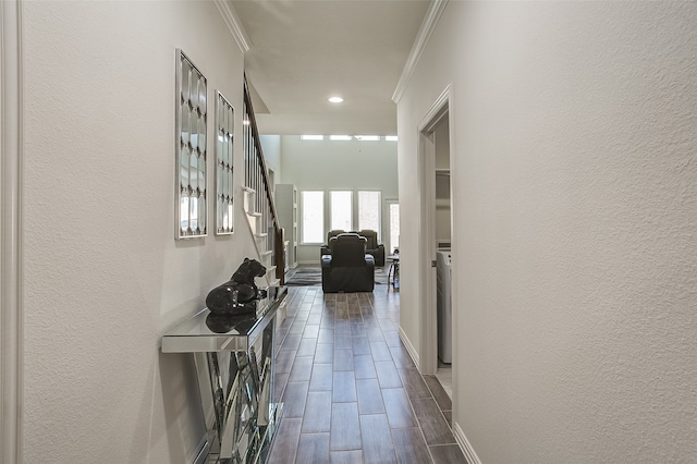 hallway with dark wood-type flooring and crown molding