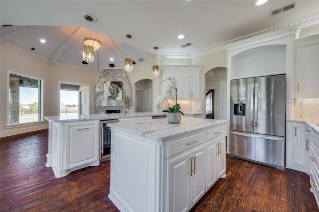 kitchen featuring stainless steel appliances, dark hardwood / wood-style floors, pendant lighting, a kitchen island, and custom exhaust hood